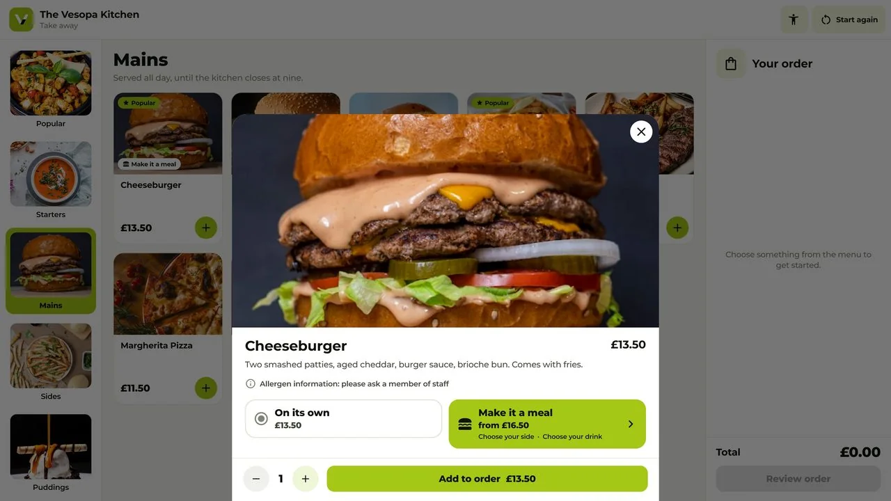A cheeseburger opened on the kiosk, with its description, allergen note, and the choice of on its own or Make it a meal.
